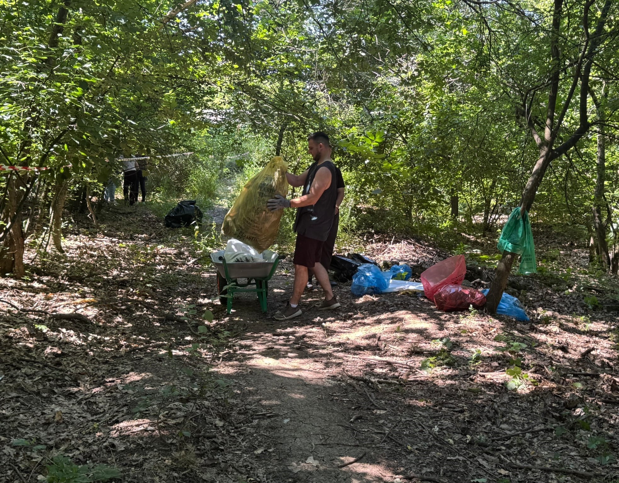 Voluntar golind un sac în roabă